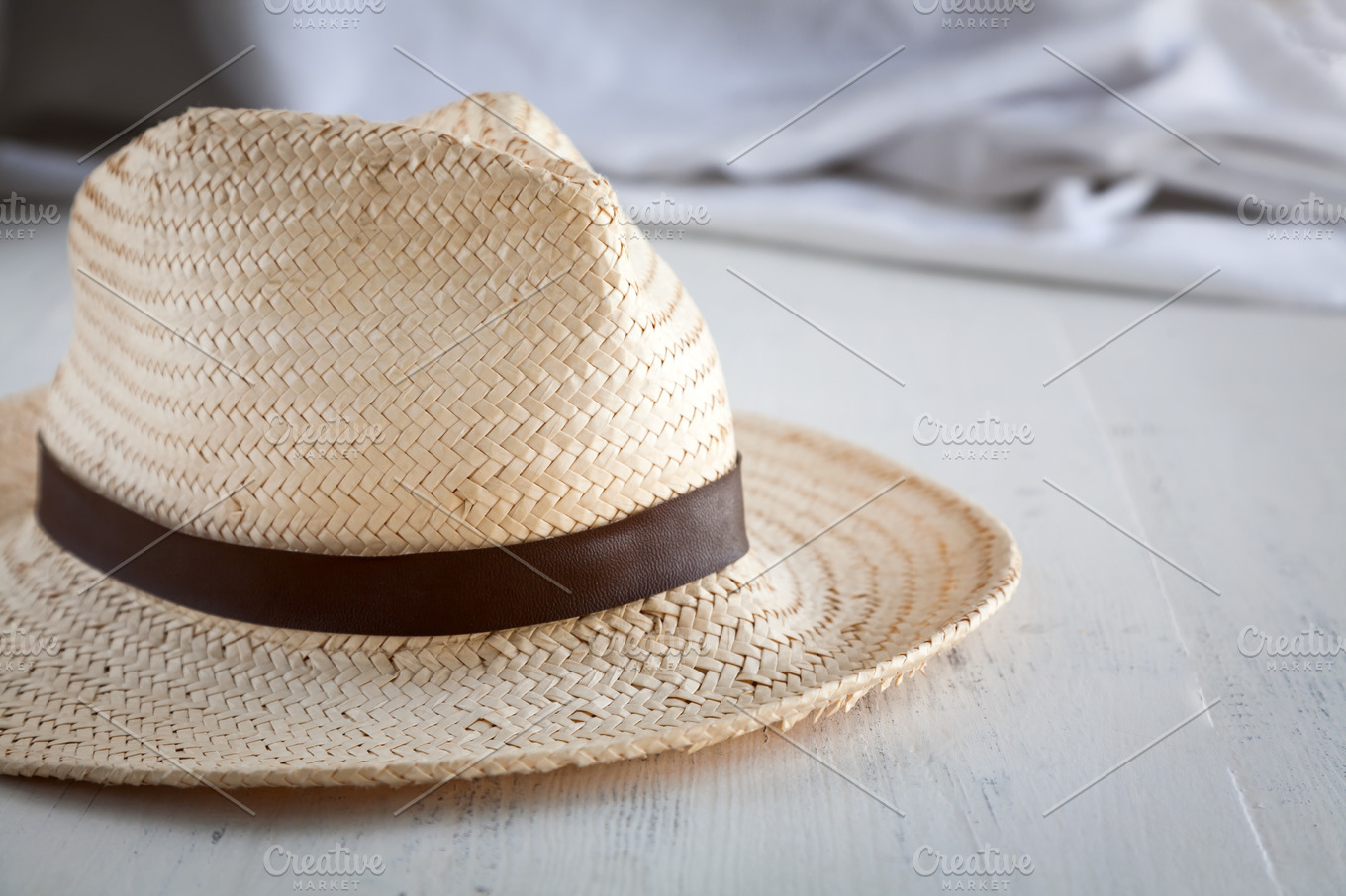 Straw hat on white table ~ Beauty & Fashion Photos ~ Creative Market