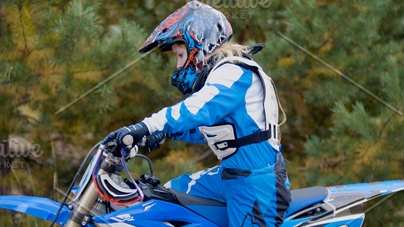 Girl mx biker - motocross racer on dirt bike at sport track in Graphics