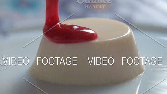 Pouring Panna Cotta With Strawberry Sauce