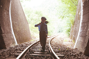 Girl walking on train tracks ~ People Photos ~ Creative Market