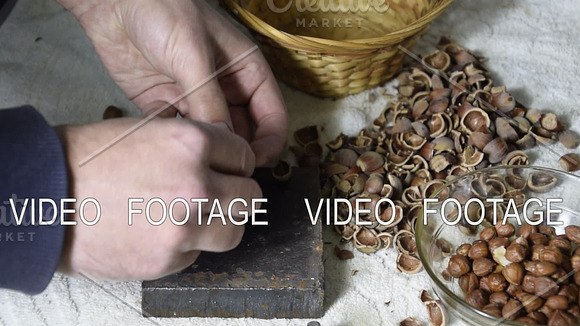 Chipping The Hazelnuts With A Hammer On The Table
