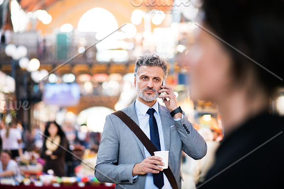 Mature Businessman With Smartphone In A City