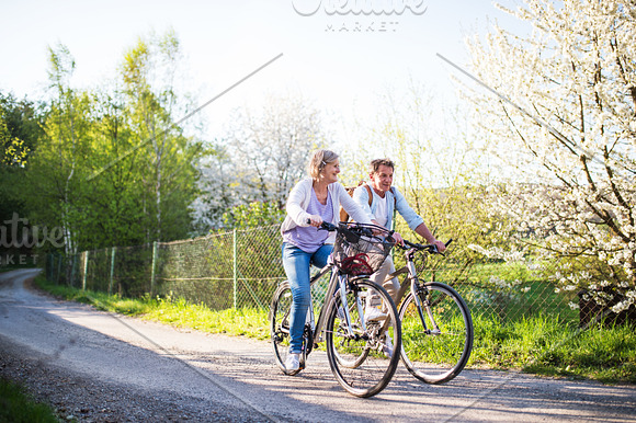 Senior Couple With Bicycles Outside In Spring Nature