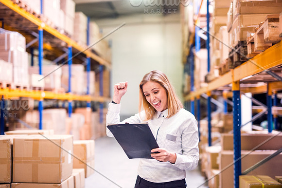 Overjoyed Female Worker Or Supervisor In A Warehouse