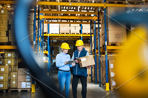 Senior Managers Or Supervisors With Tablet Working In A Warehouse Controlling Stock